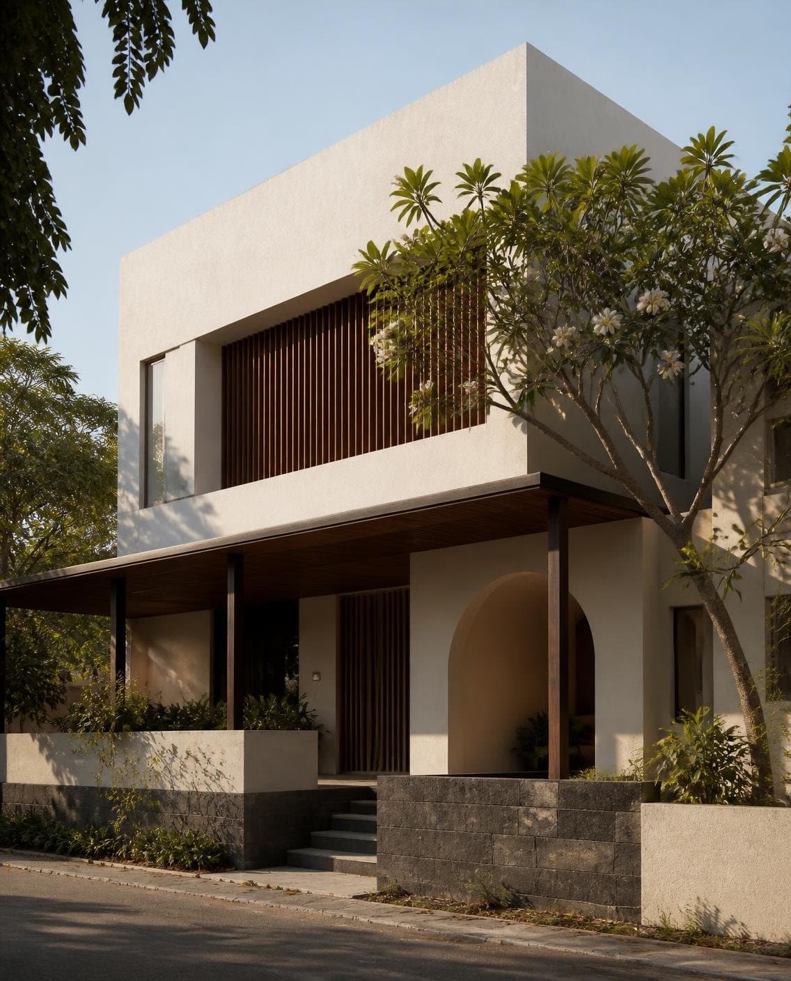 Illustrative two-storey residence with white plaster volumes, timber louvres, a stone plinth and an arched verandah